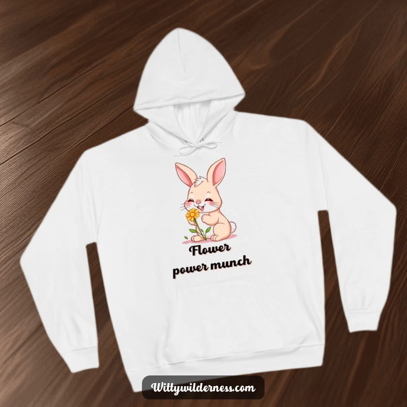 Funny hoodie featuring a giggling bunny gently nibbling on a small wildflower, evoking a sense of peace and natural delight.